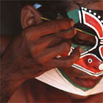 Kathakali dancer applying makeup